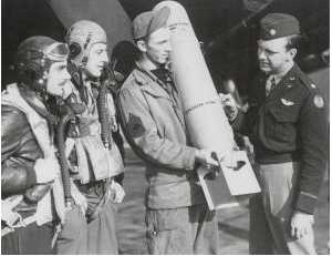 Examining an M46 Photoflash Bomb rated at 700 Million Candles are 1st Lt Robert P Walker (Pilot) 1st Lt William P Mishkho (Navogator) MSgt James M Tenille (Cief Armourer) Major Willis D Locke CO 654 Sdqn 25BG