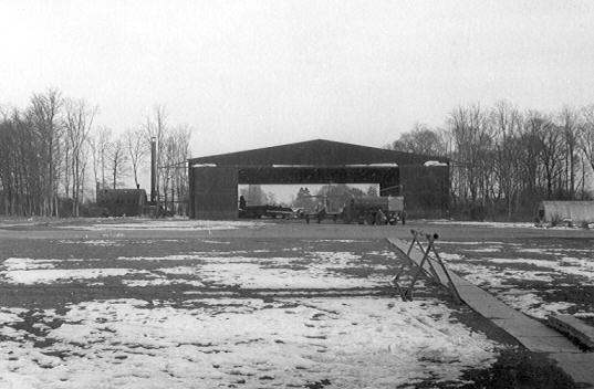 This is the old 527 Squadron hangar on the Griston side of the airfield at RAF Watton. Taken in 1954/55 it shows a Meteor NF 14 inside the hangar, you can tell the difference from the NF11 as that had a glasshouse type of canopy (Small panes of Perspex) whereas the NF14 had a one piece clear cockpit canopy. If you look closely you can see the tower of Griston Church through the hangar's open doors. This Hangar was a survivor from WWII, it was one of two built on the Griston side of the airfield for use by the USAAF 3rd Strategic Air Depot.