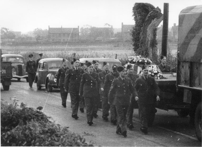 Marching down Norwich road. Officers quarters in background.